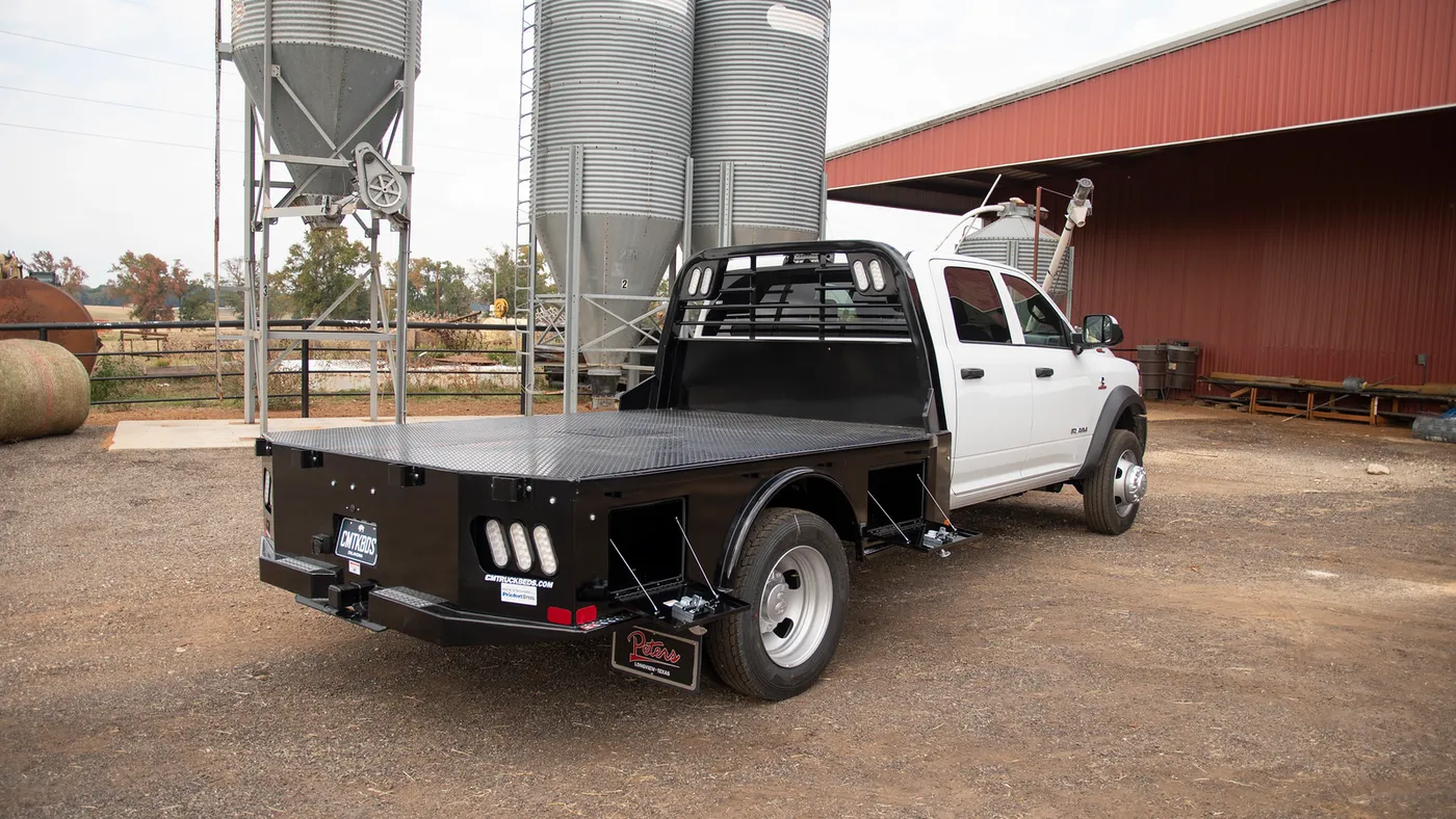 CM SK steel skirted flatbed on a dually truck at a farm site